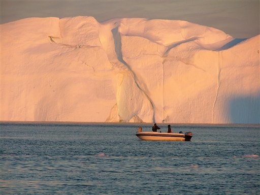Local Greenlanders fishing and hunting between giant icebergs 