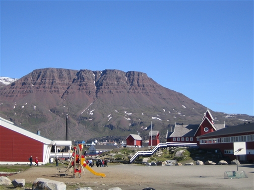 Qeqertarsuaq with its characteristic basalt mountains rising in the background